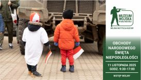 Baner. Dzieci podziwiają maszynę wojskową. Dzieci obrane w barwy narodowe